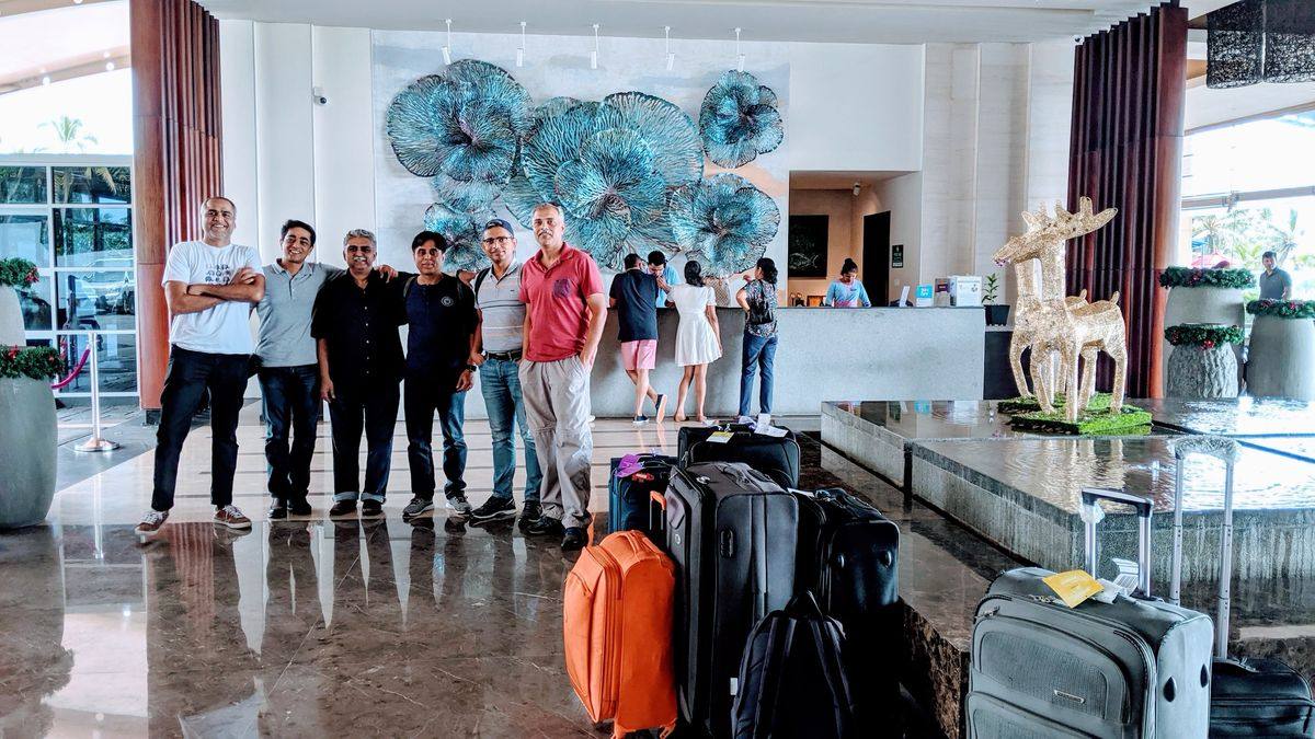 A group arriving at their hotel with luggage, met by our team